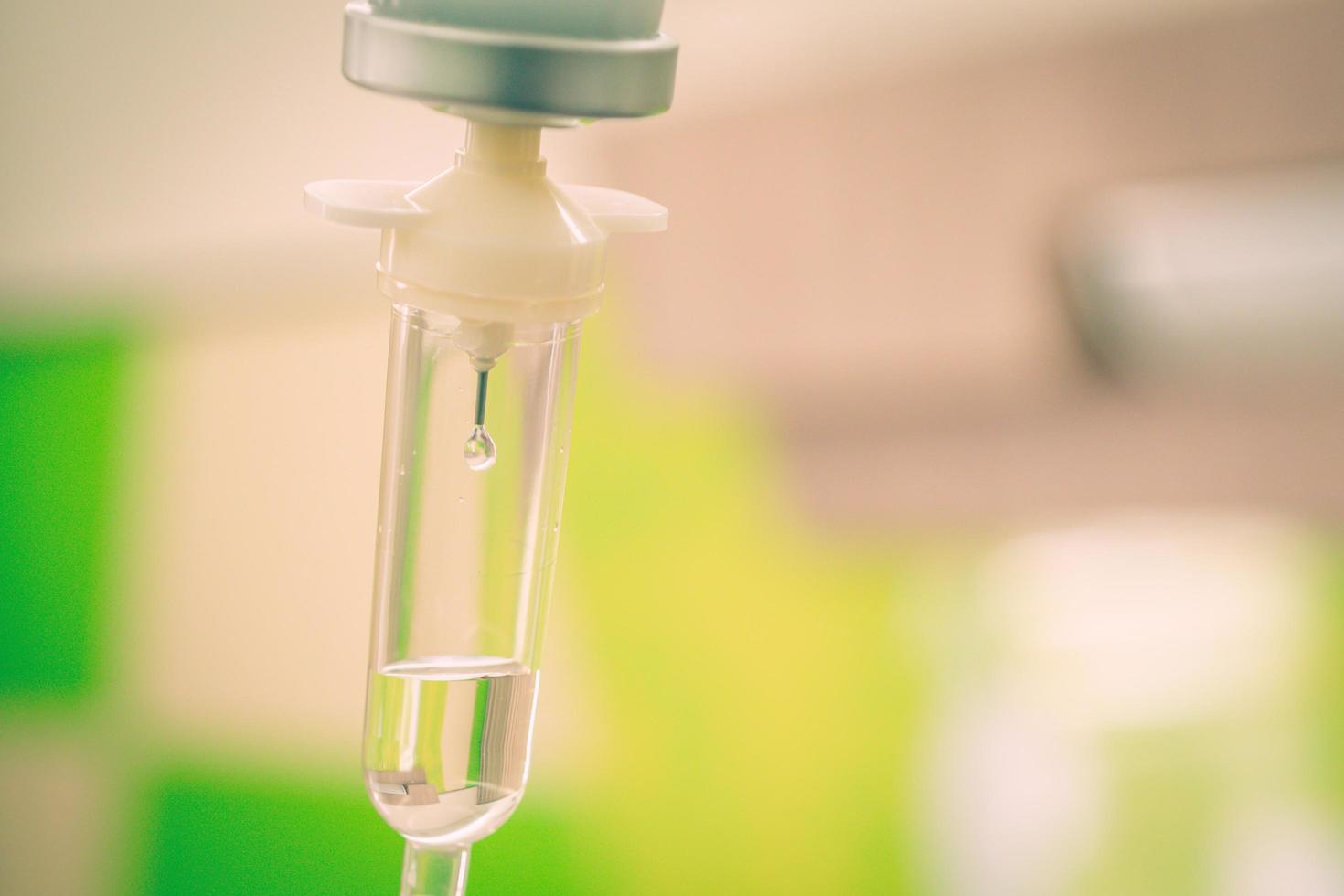 Saline solution drip for treatment patient in the hospital. photo