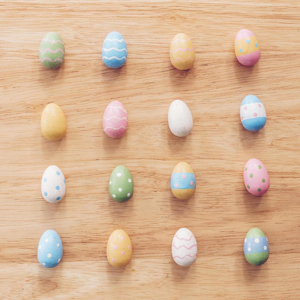 Colorful easter eggs on wooden table background with vintage toned. photo