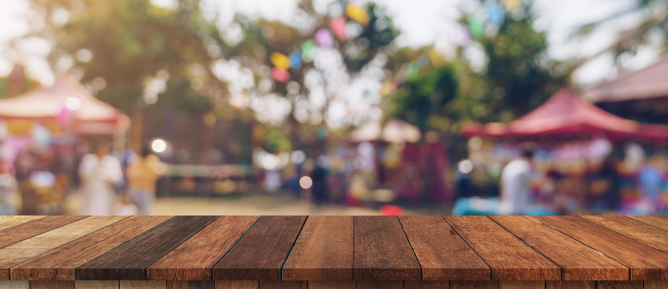 Empty wood table and defocused bokeh and blur background of garden trees in sunlight, display montage for product. photo