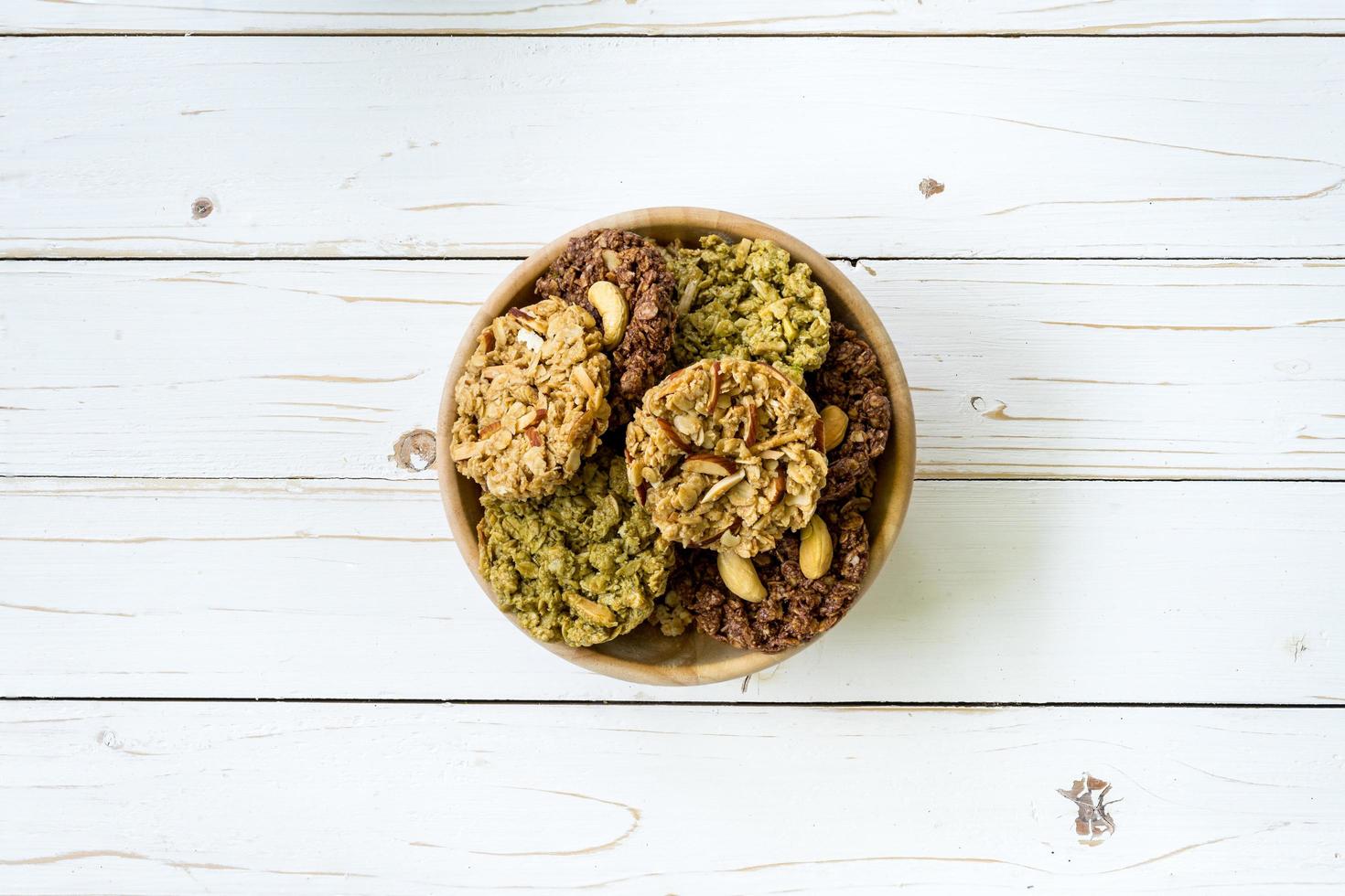 top view granola bar in bowl on wood table background. photo