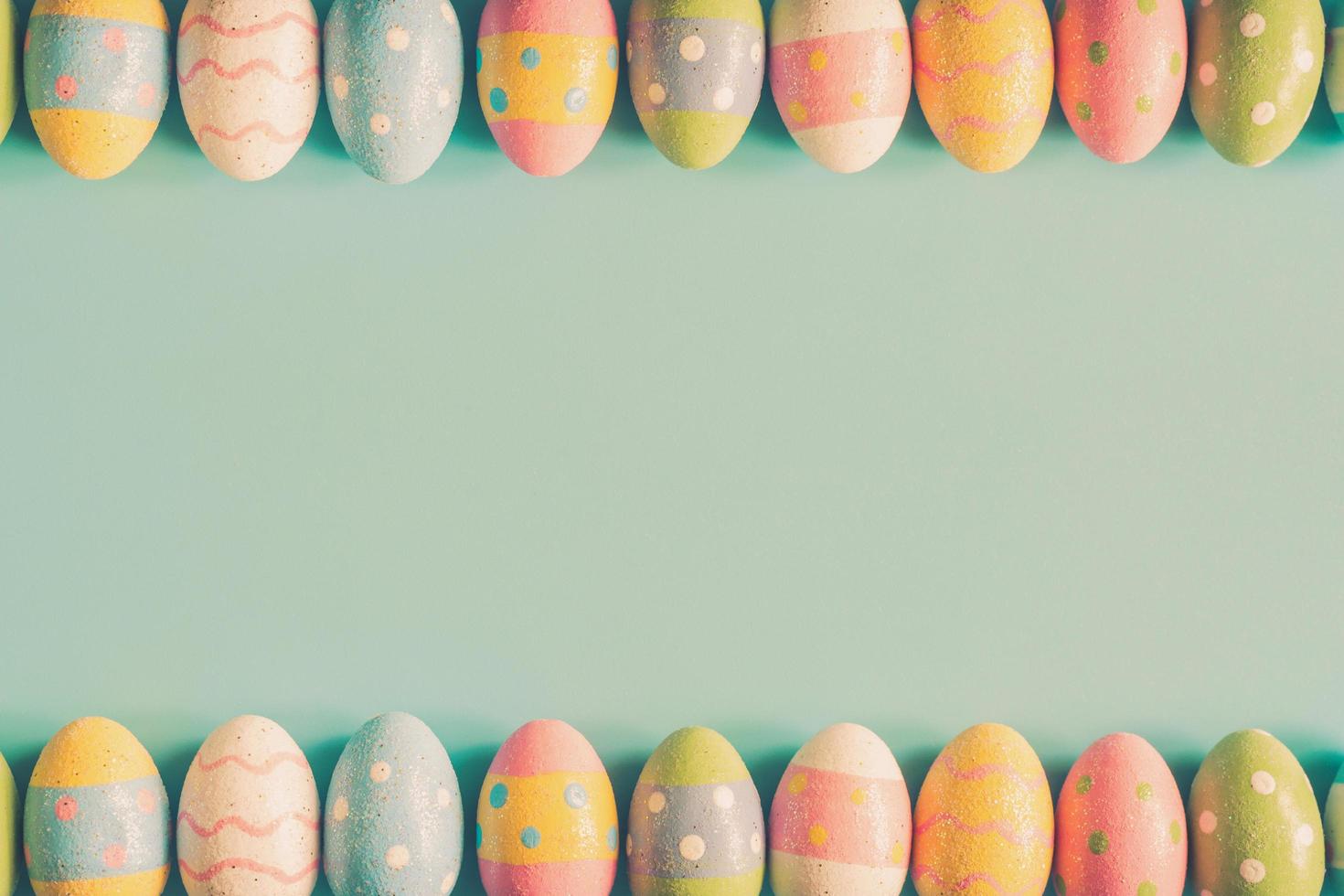 Coloeful easter eggs on pastel color background with space. photo