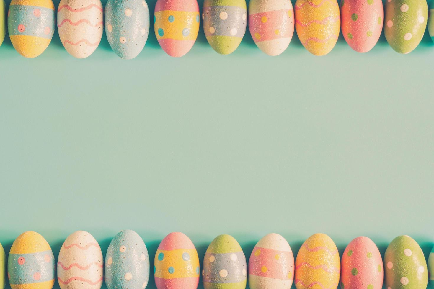 Coloeful easter eggs on pastel color background with space. photo