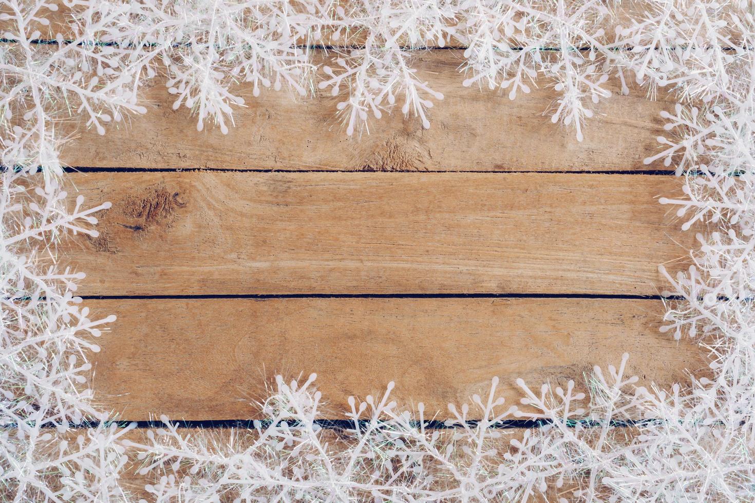 Wooden brown christmas background with snowflakes and christmas decoration. photo