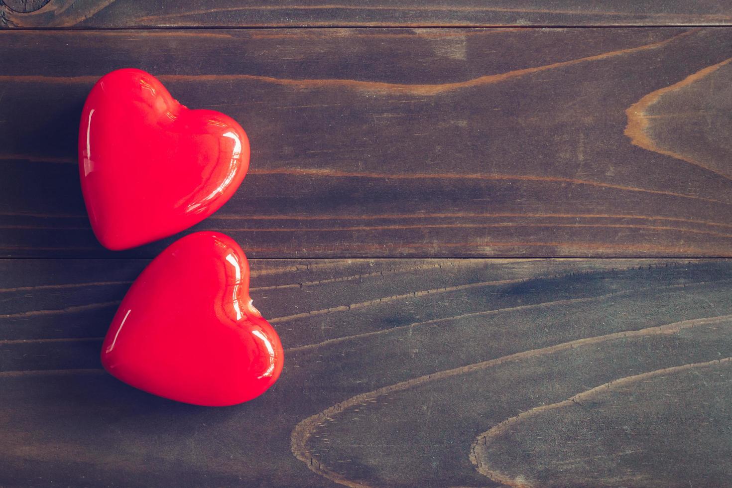 red heart on wood table background with copy space photo