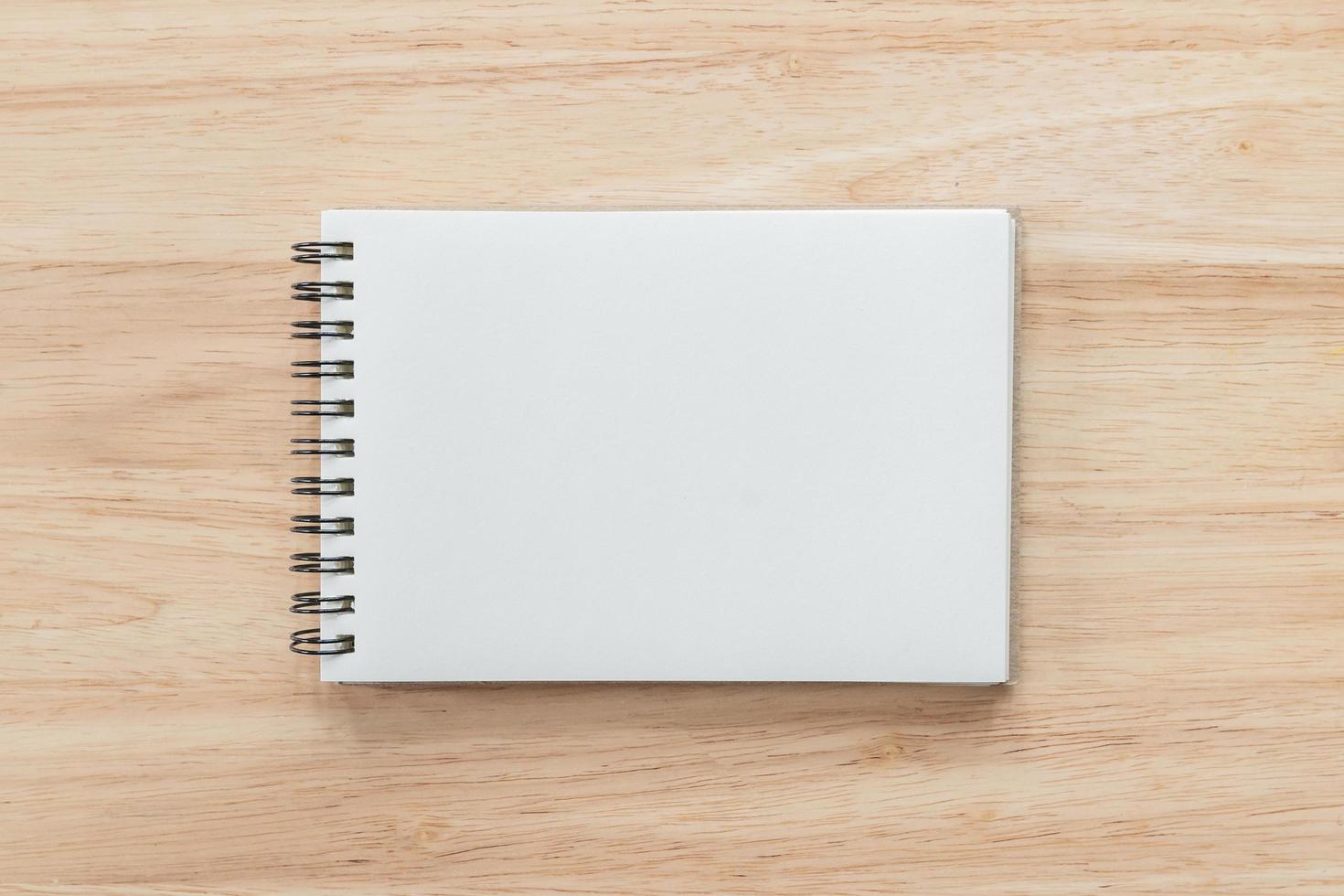 Top view of blank notebook and natural light on wooden table. photo