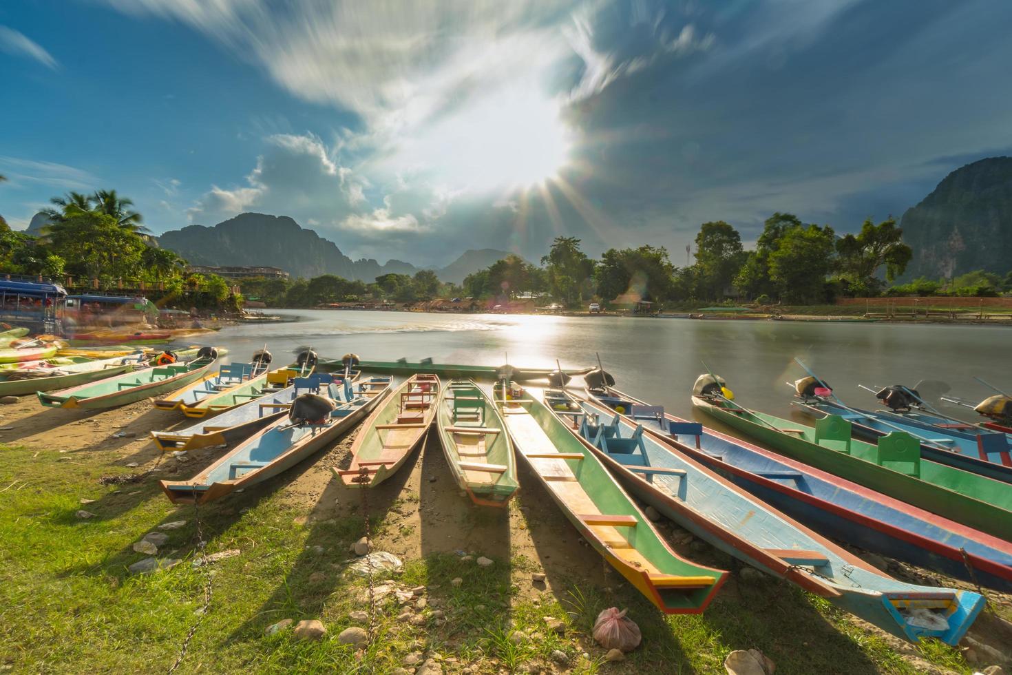 Long exposure and long tail boats on naw song river in Vang vieng, Laos. photo