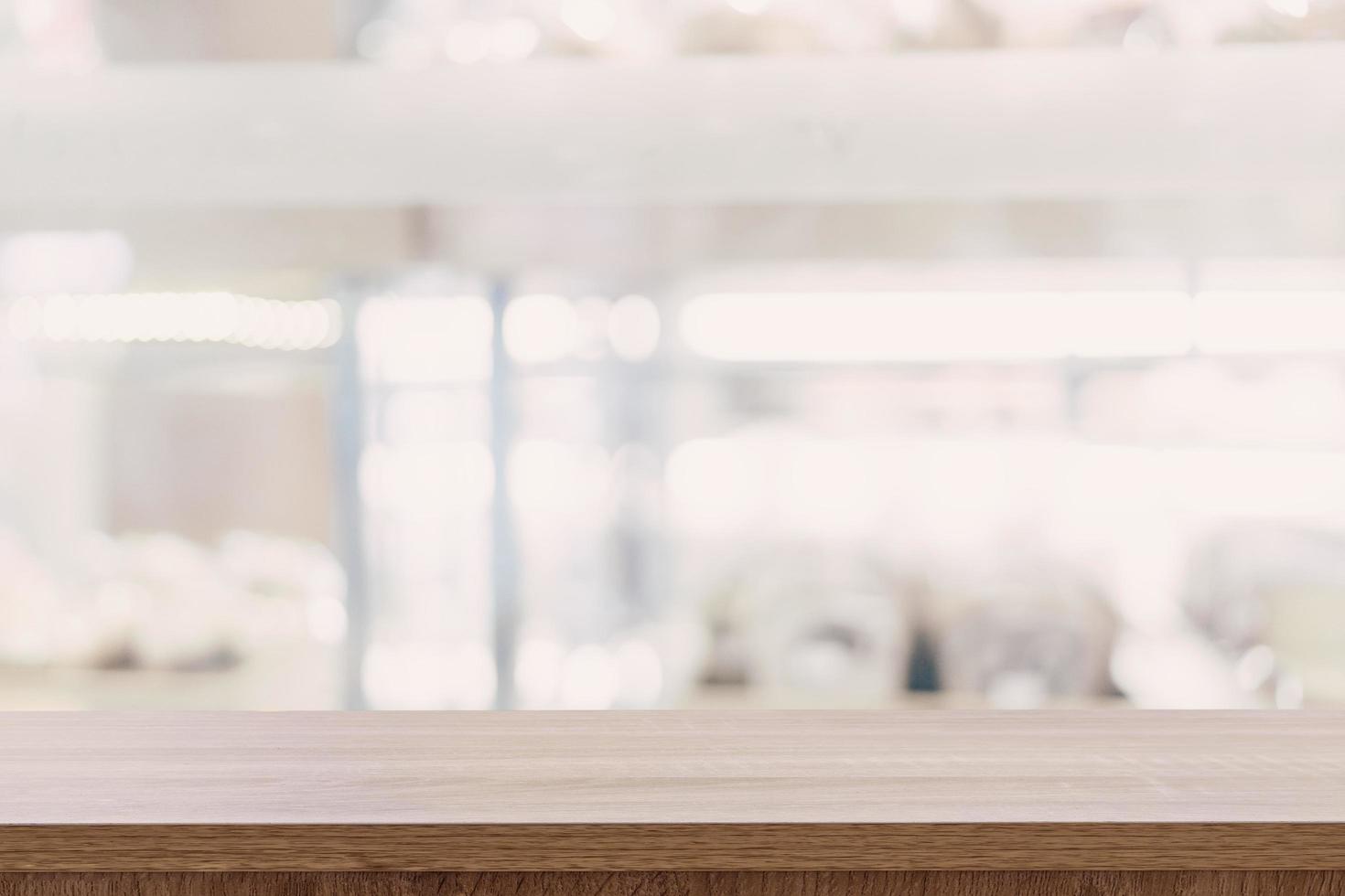 Empty wooden table top with blurred modern shopping mall background for product display and montage. photo