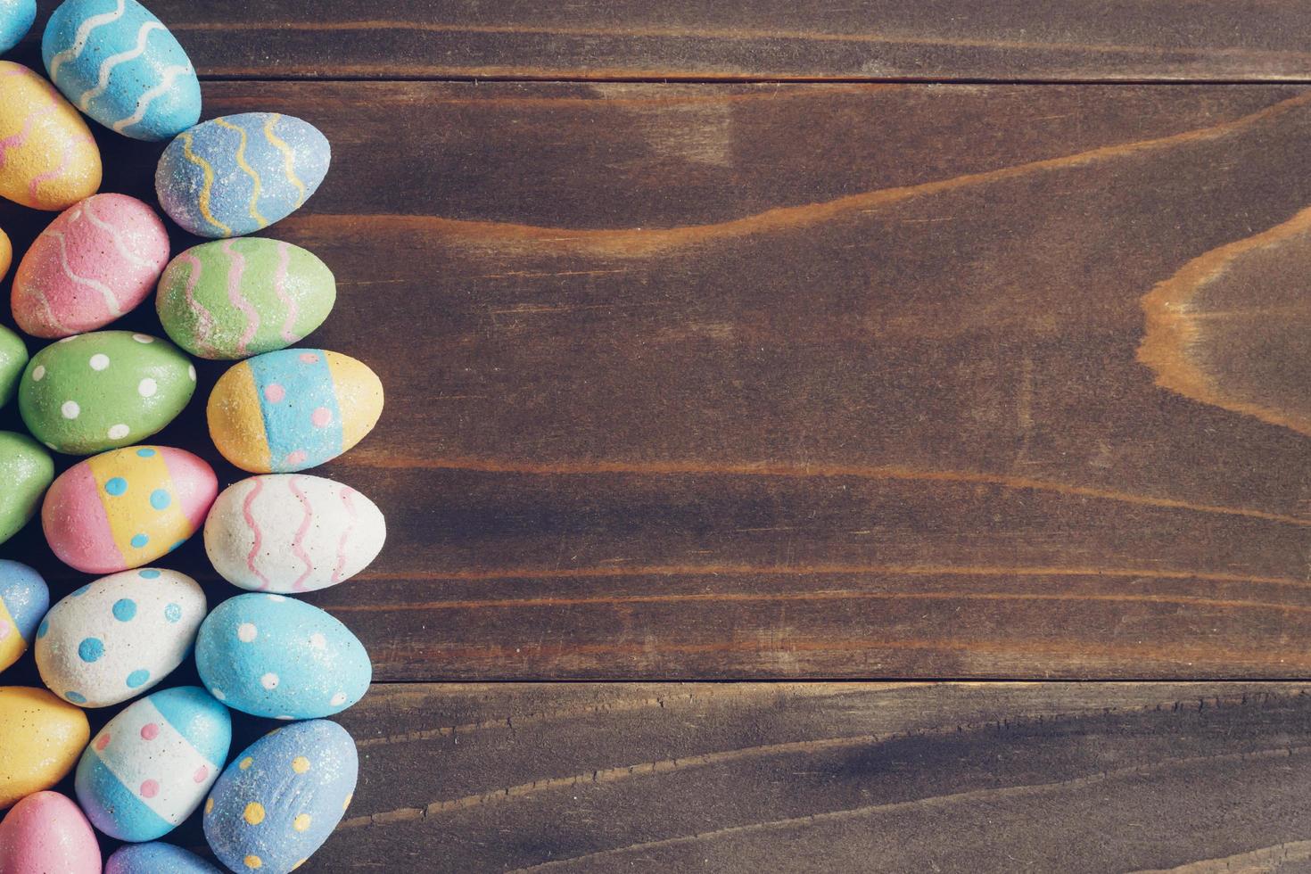 Top view of Easter eggs on rustic wood background with copy space photo