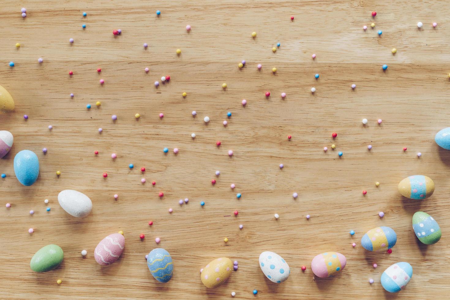 Easter eggs on on wood background top view with natural light. Flat lay style. photo