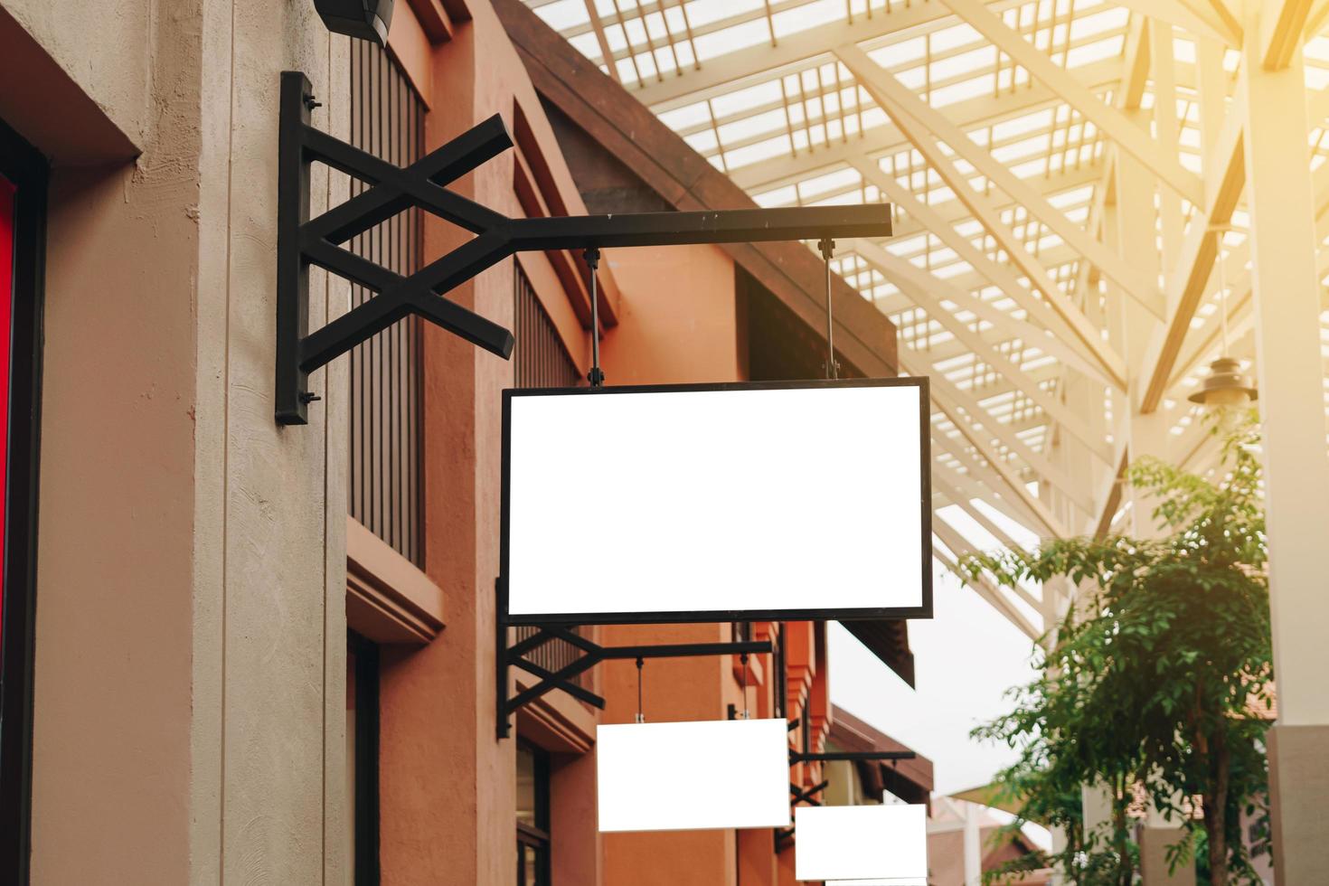 Empty signage and blank mock up hanging on street with copy space photo