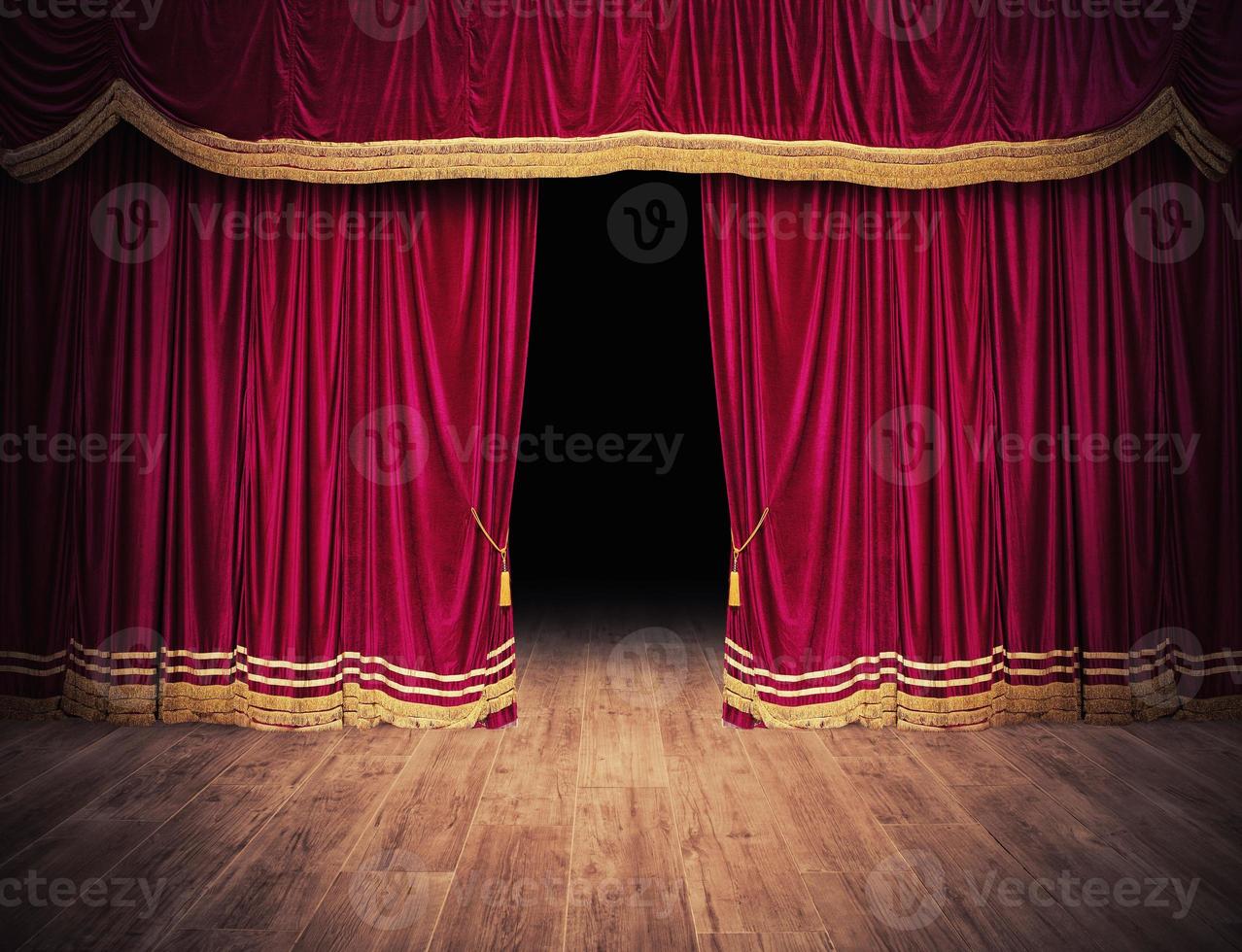 The red curtains are opening for the theater show photo