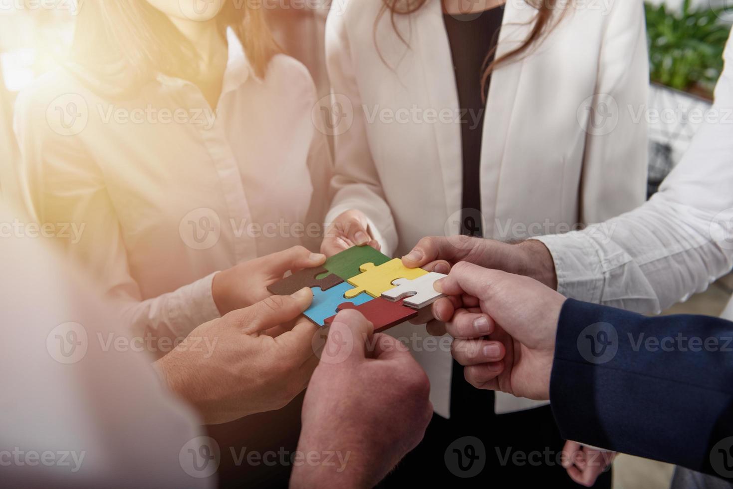 Teamwork of partners. Concept of integration and startup with puzzle pieces. photo