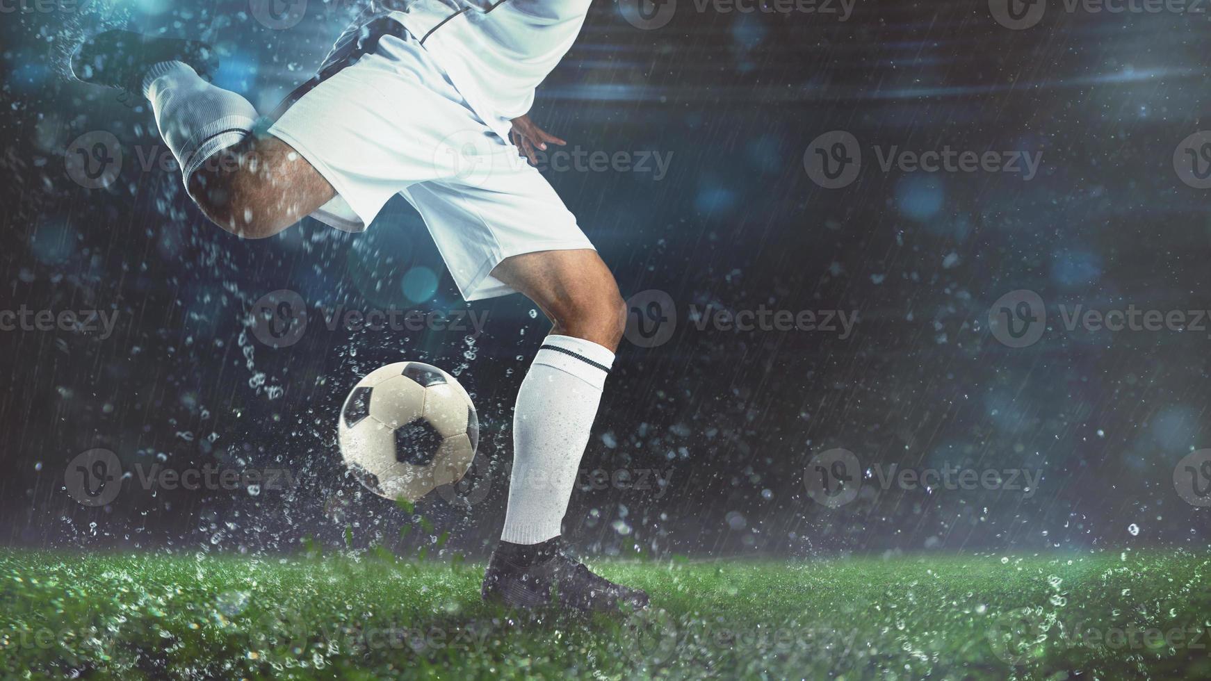 Close up of a soccer scene at night match with player in a white uniform kicking the ball with power photo