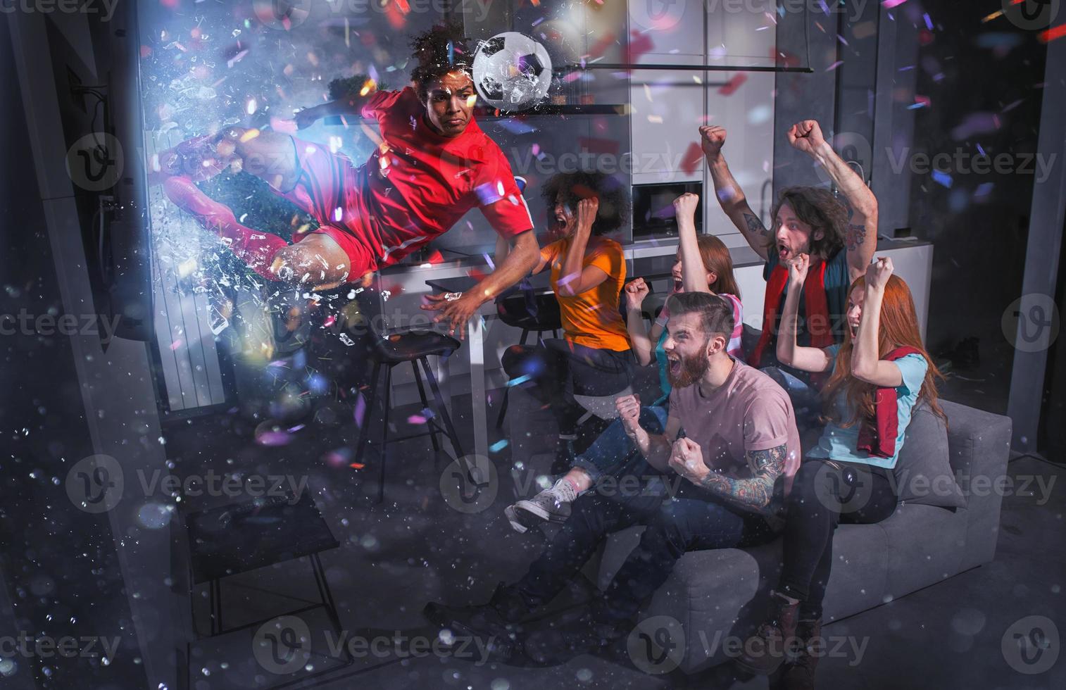 Group of friends watch a football match on television with a soccer player who exits from screen photo