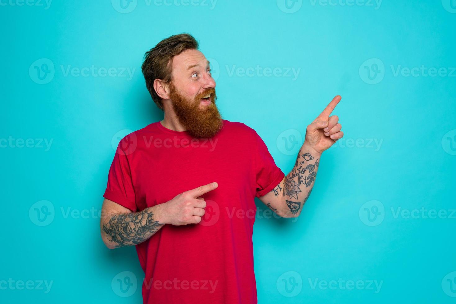 Man is wondered and indicates something with hand photo