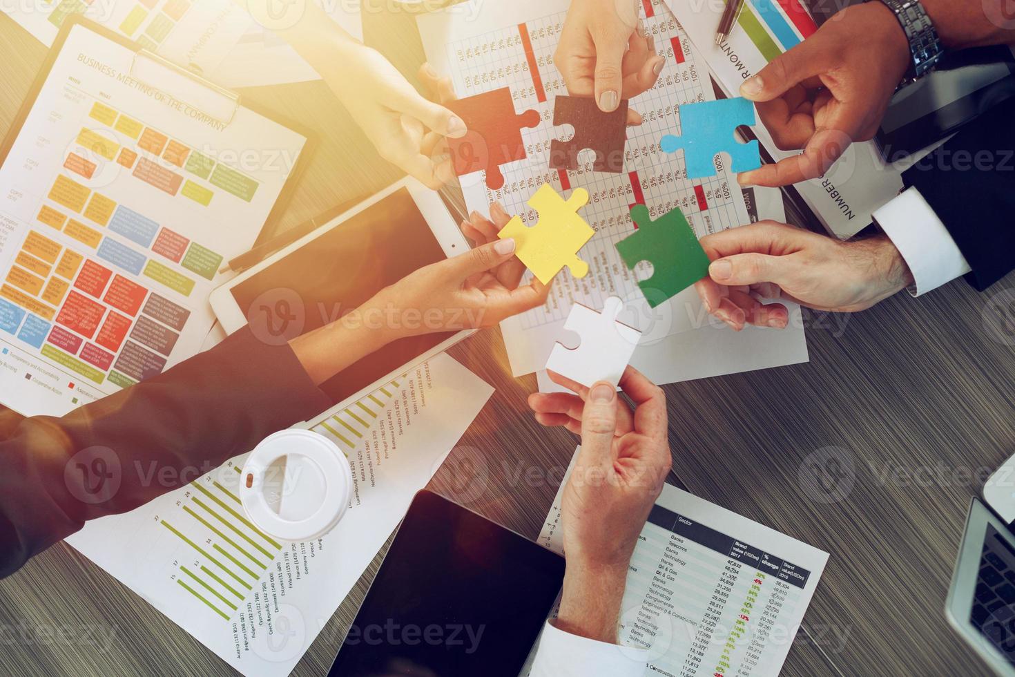 Teamwork of partners connect puzzle pieces as integration and startup photo