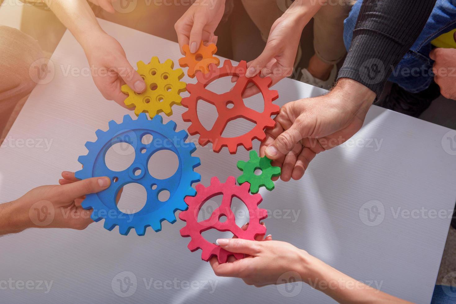 Business team connect pieces of gears like a teamwork and partners photo