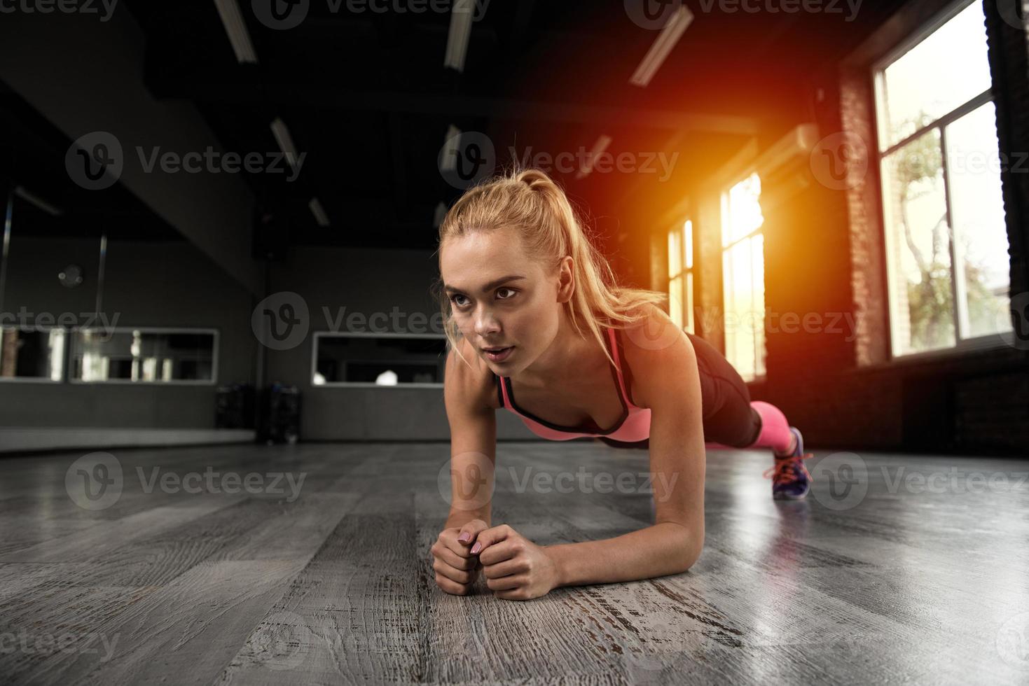 Blonde girl working out at a gym photo