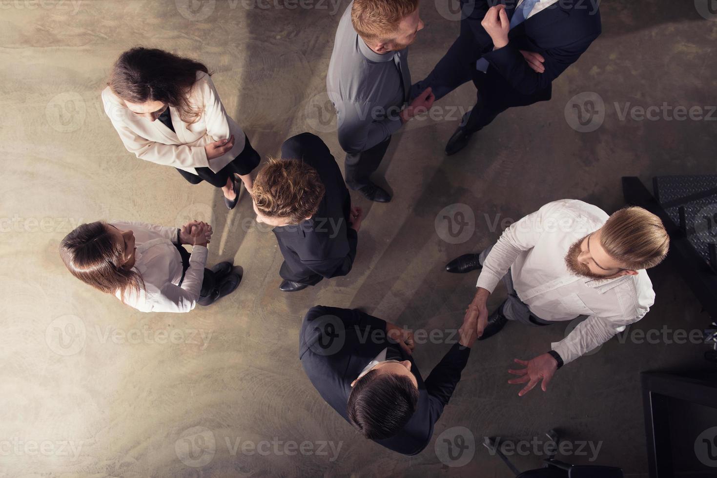 Handshaking business person in office. concept of teamwork and partnership. double exposure photo