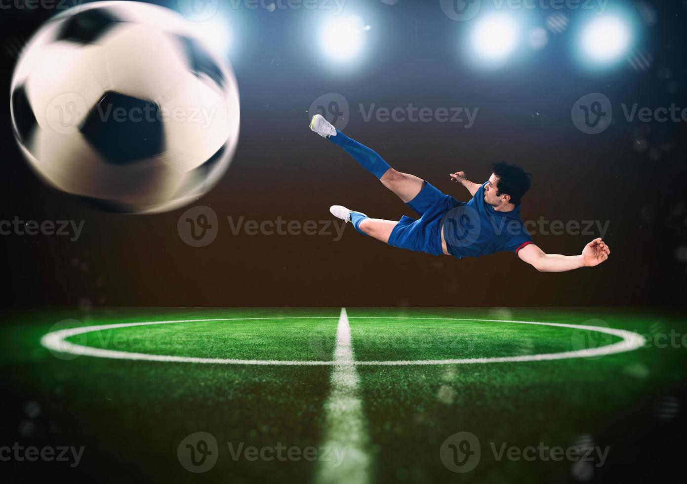 Football scene at night match with player kicking the ball with power photo