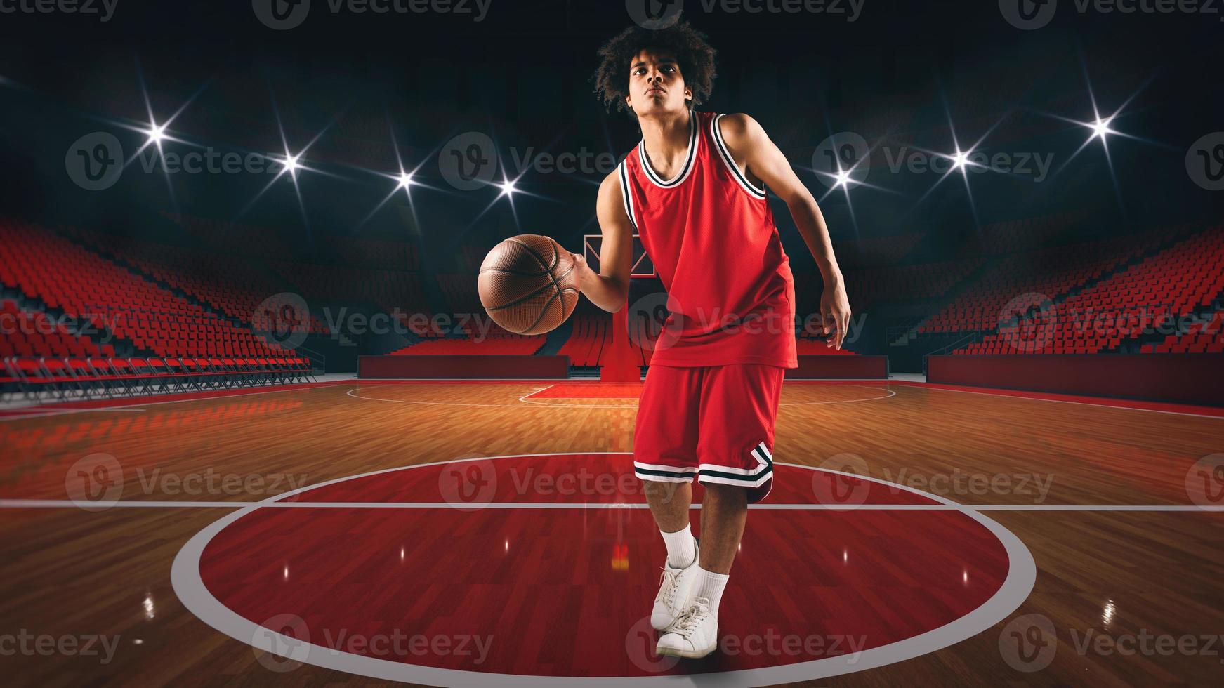 Young African American boy with basketball in the middle of the stadium photo