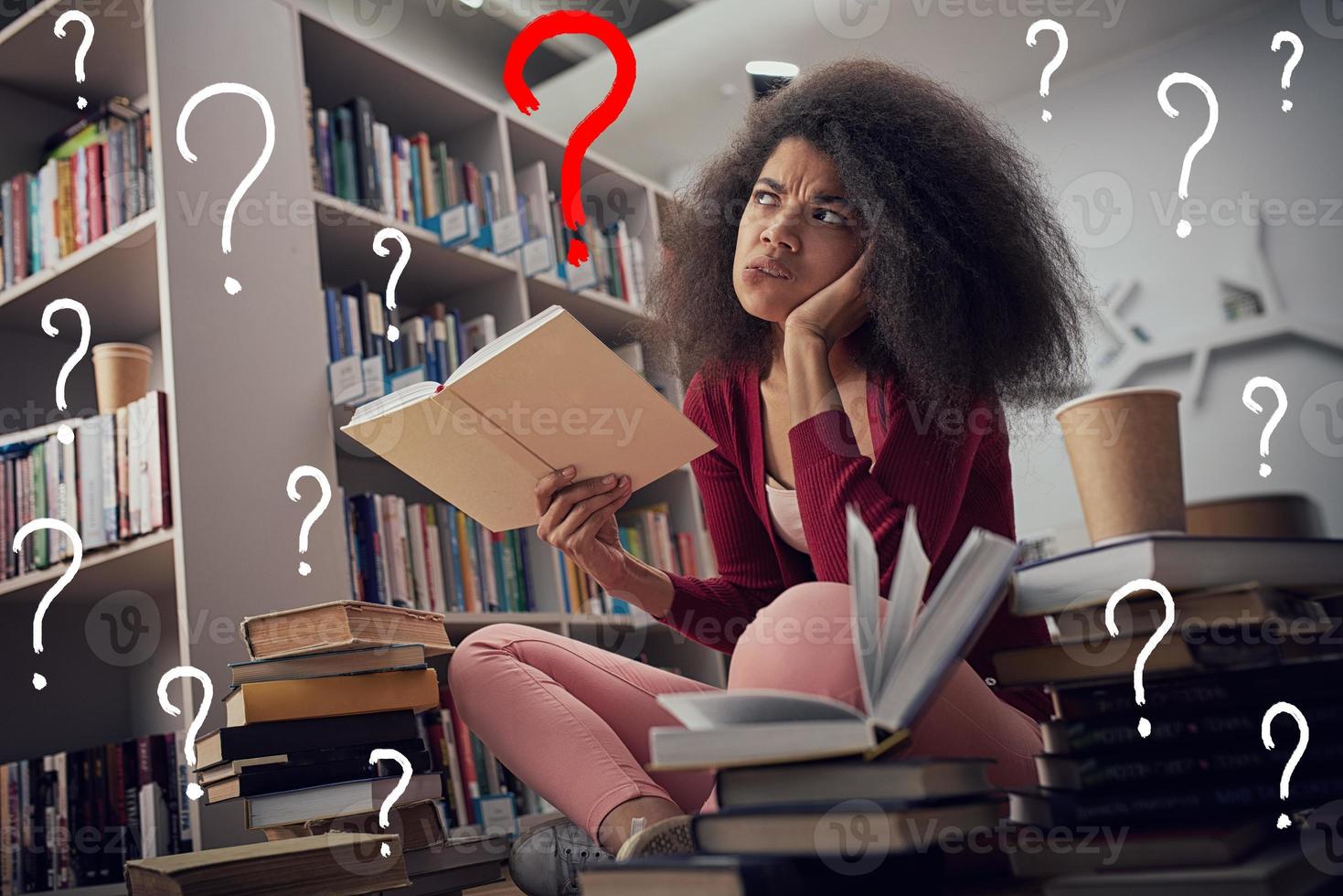 Tired university student has difficulty to study. Concept of stress, question and difficulty photo