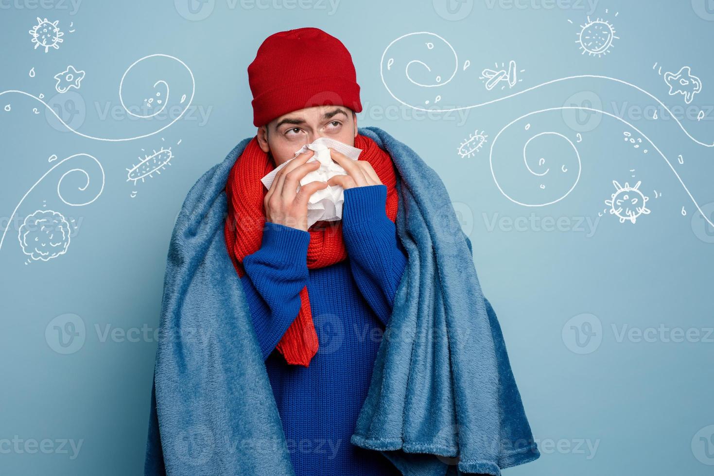 Boy caught a cold and uses pills to heal. Studio on Cyan background photo