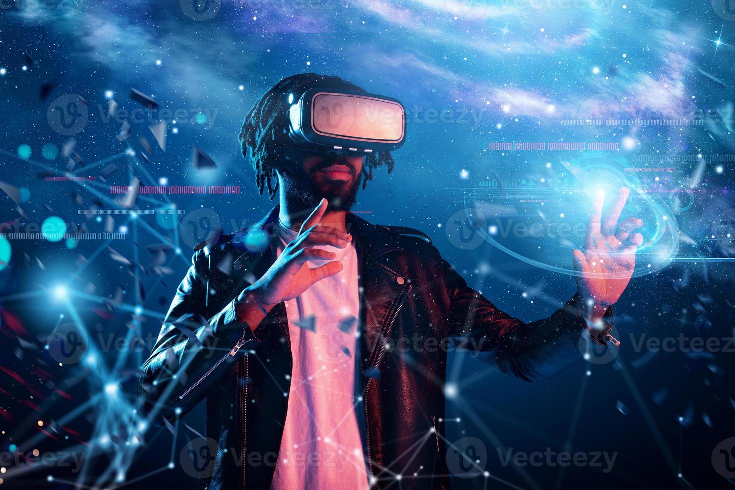 Boy with VR glasses play with a virtual videogame photo