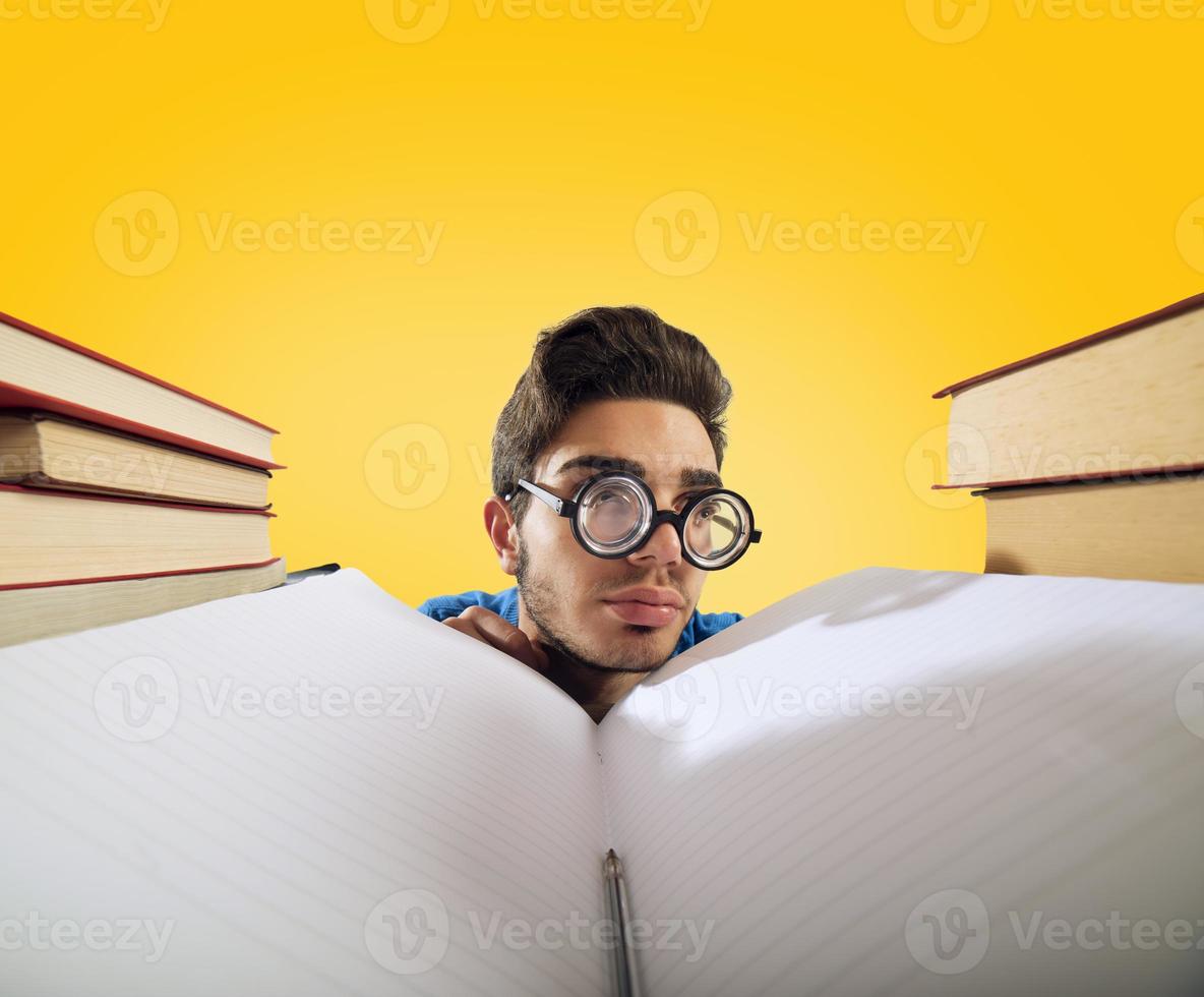 Exhausted student is studying hard on the desk photo