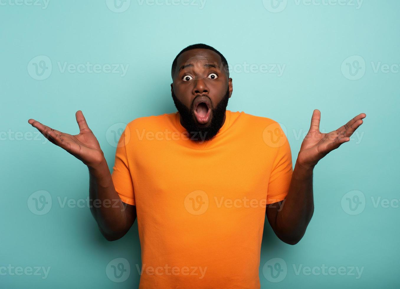 Amazed and shocked expression of a boy over cyan background photo