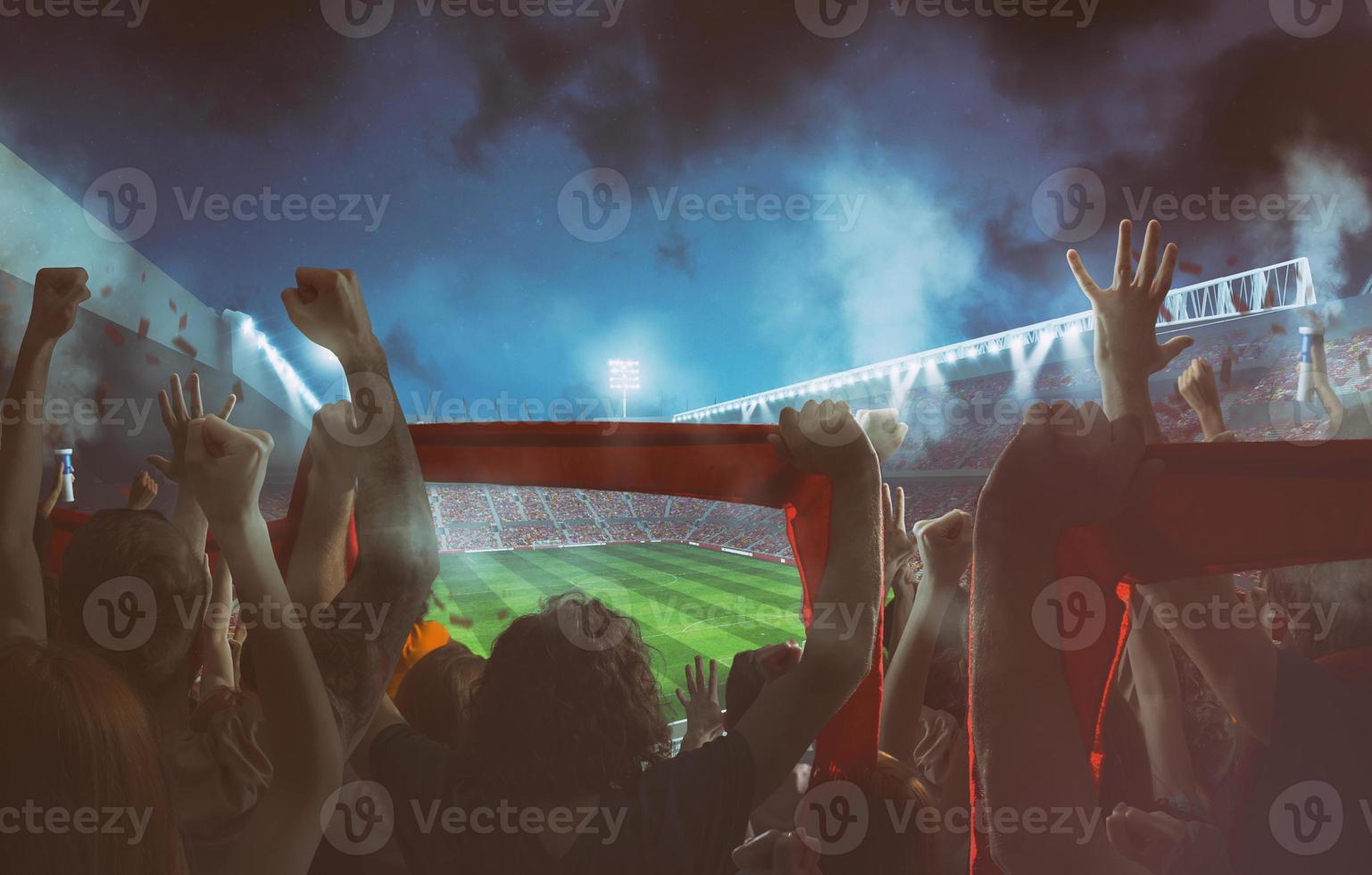 Football scene at night match with with cheering fans at the stadium photo