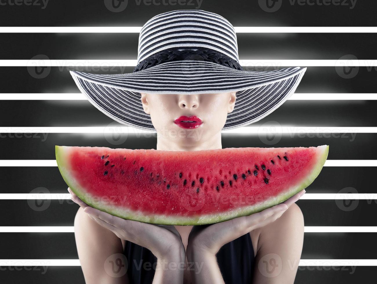 Girl in swimsuit with red watermelon in hand photo