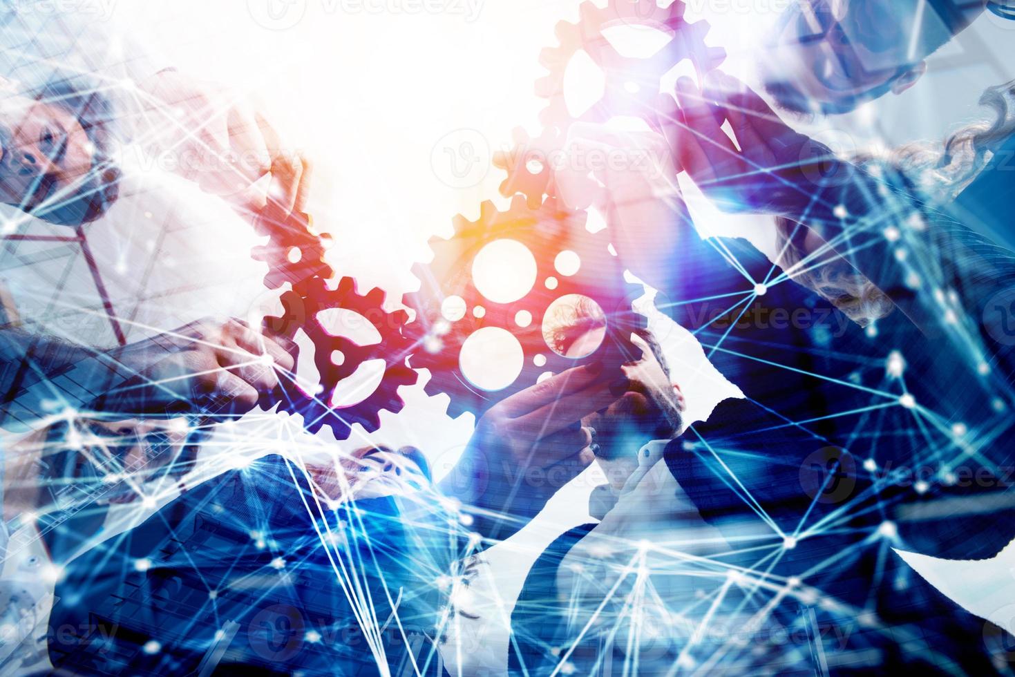 Business team connect pieces of gears. Teamwork, partnership and integration concept. double exposure with network effects photo