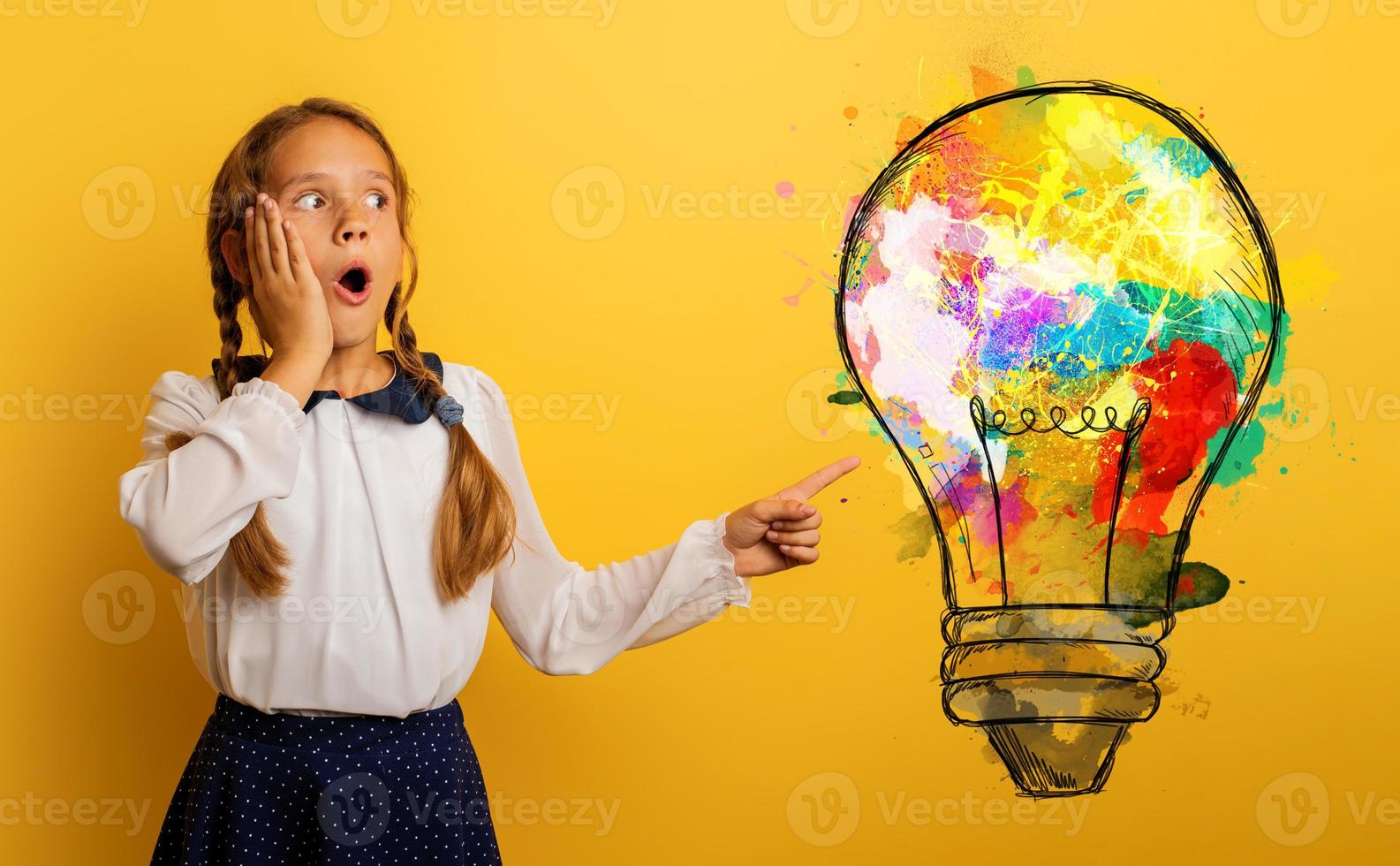 Young student has a new idea with a big lightbulb . Yellow background photo