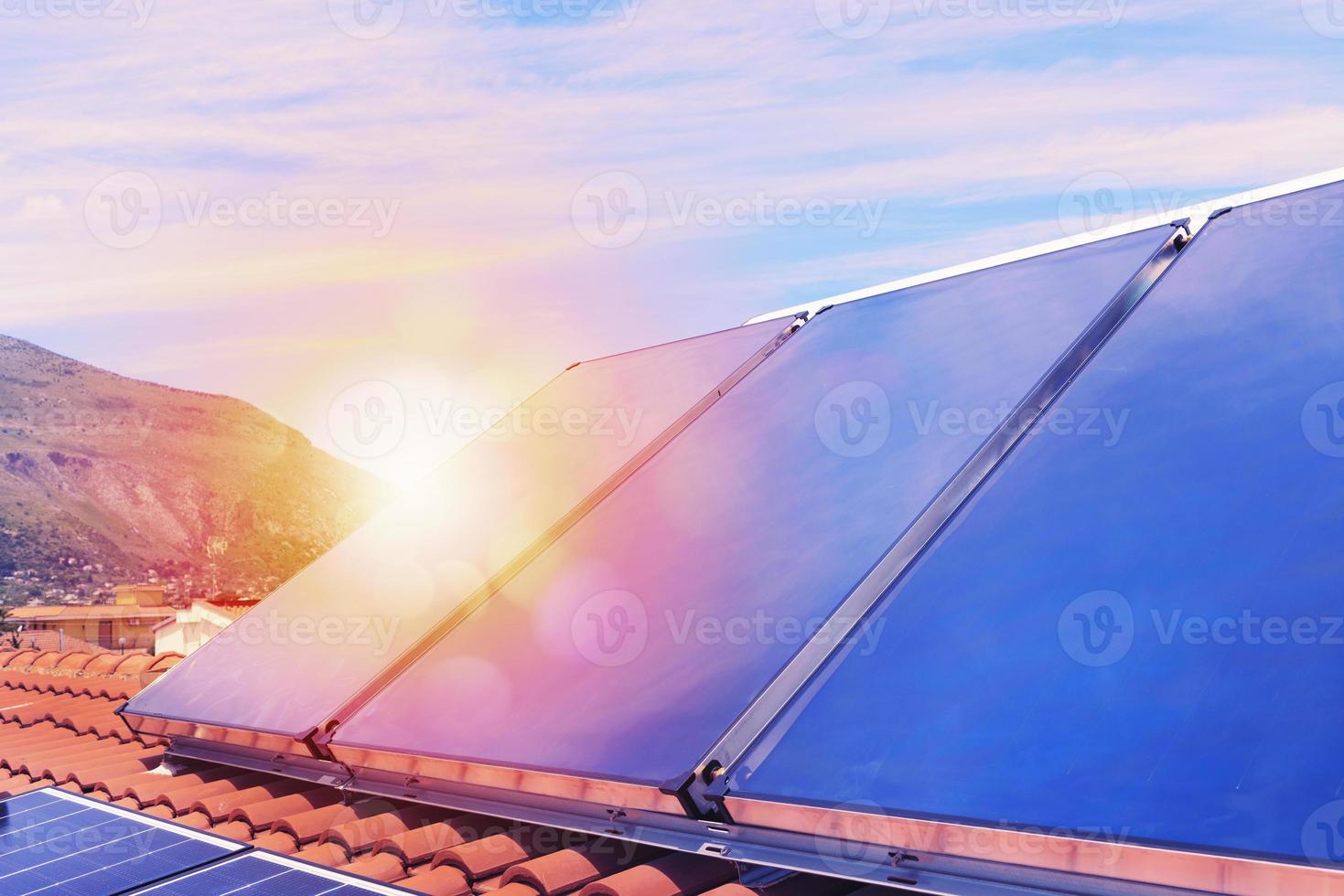 Renewable energy system with solar panel for electricity and hot water photo