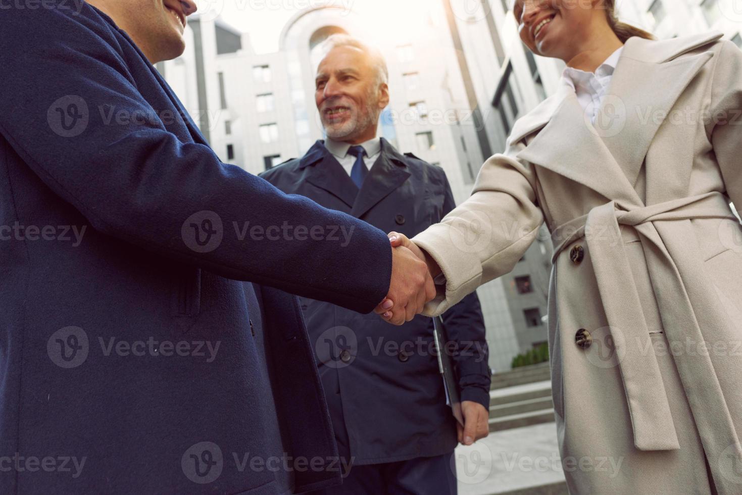 Handshaking business person in office as teamwork and partnership. photo