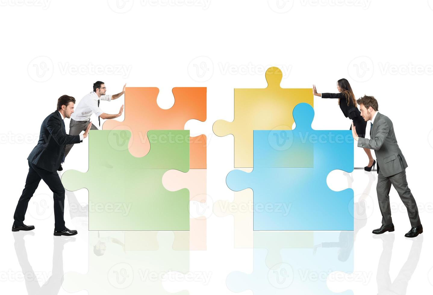Concept of teamwork and partnership with businesspeople and puzzle. photo