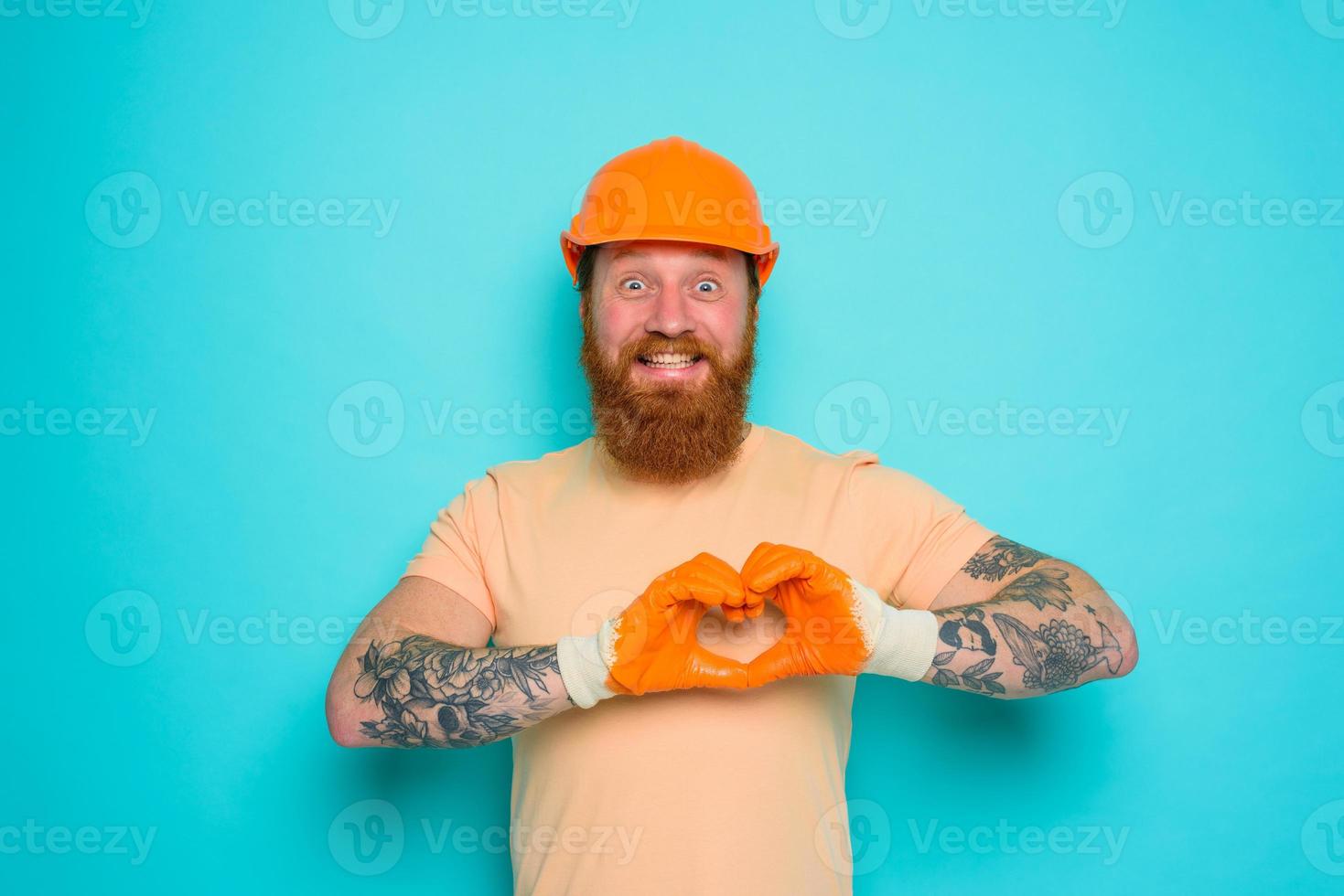 Worker with yellow hat is happy about his work photo