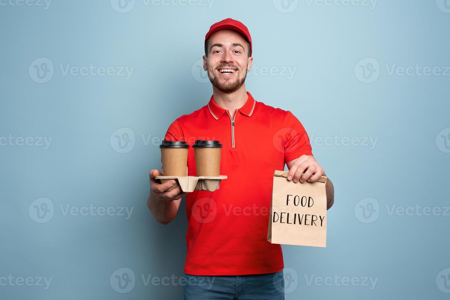 Courier is happy to deliver hot coffee and food. Cyan background photo