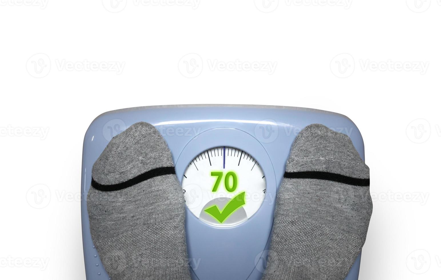 Person check his weight with a balance that shows ok message photo