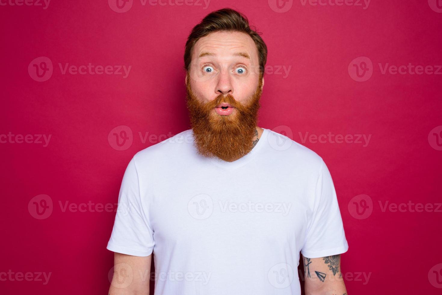 amazed isolated man with beard and white t-shirt photo