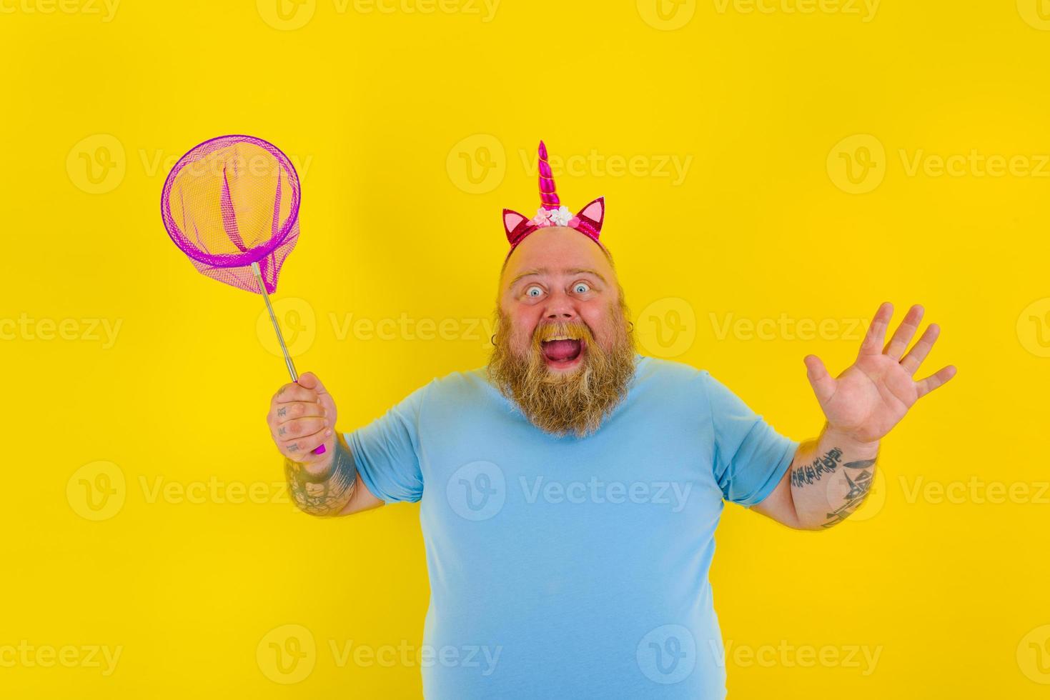 Fat happy man with headband play with sea net photo