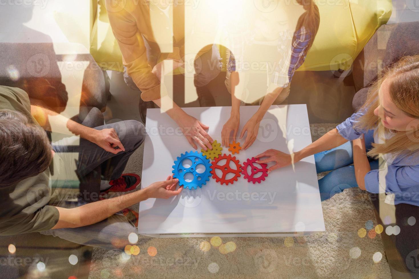 Business team connect pieces of gears like a teamwork and partners photo