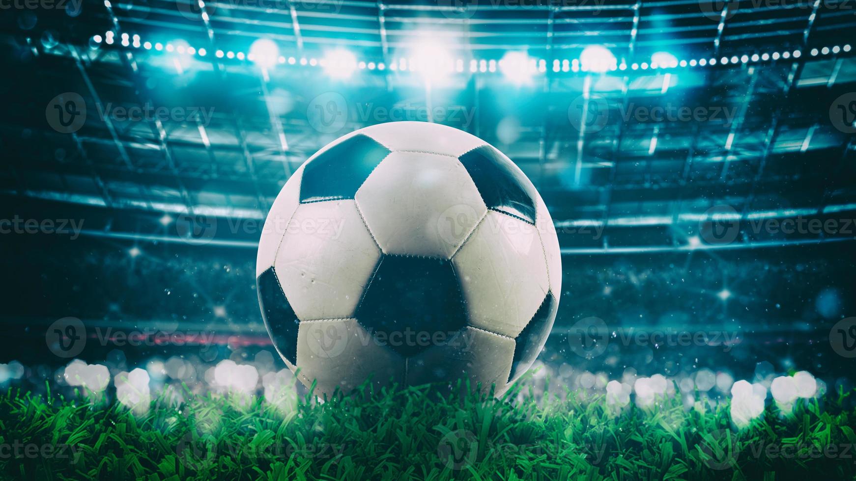Close up of a soccer ball in the center of the stadium illuminated by the headlights photo