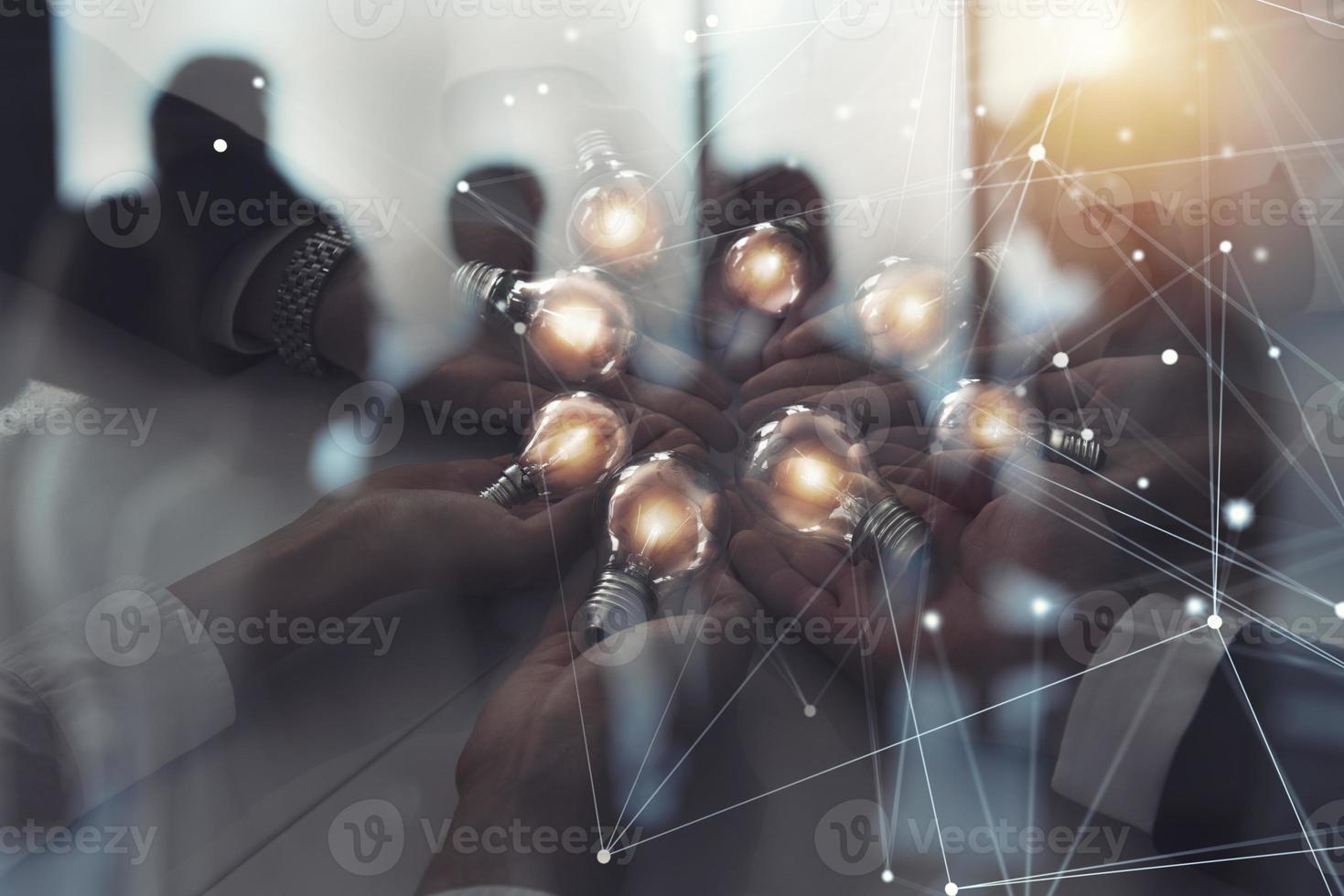 Teamwork and brainstorming concept with businessmen that share an idea with a lamp with network lines. Concept of startup. Double exposure photo