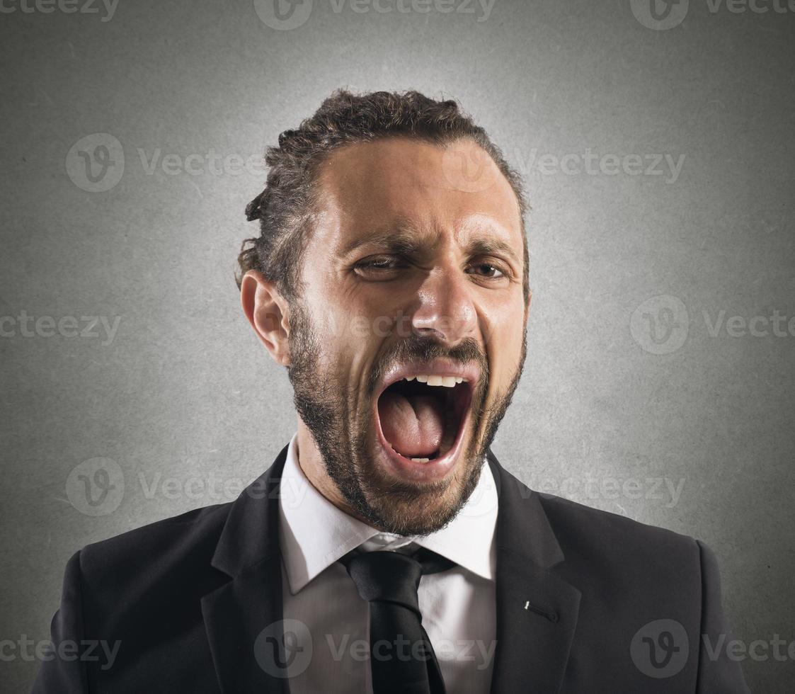 Furious businessman screaming photo