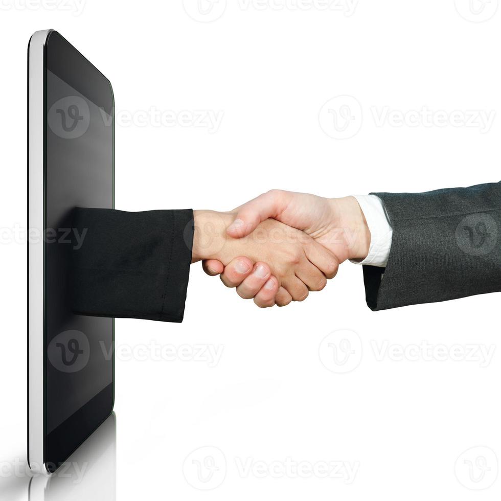 Handshake between two people through a mobile device photo