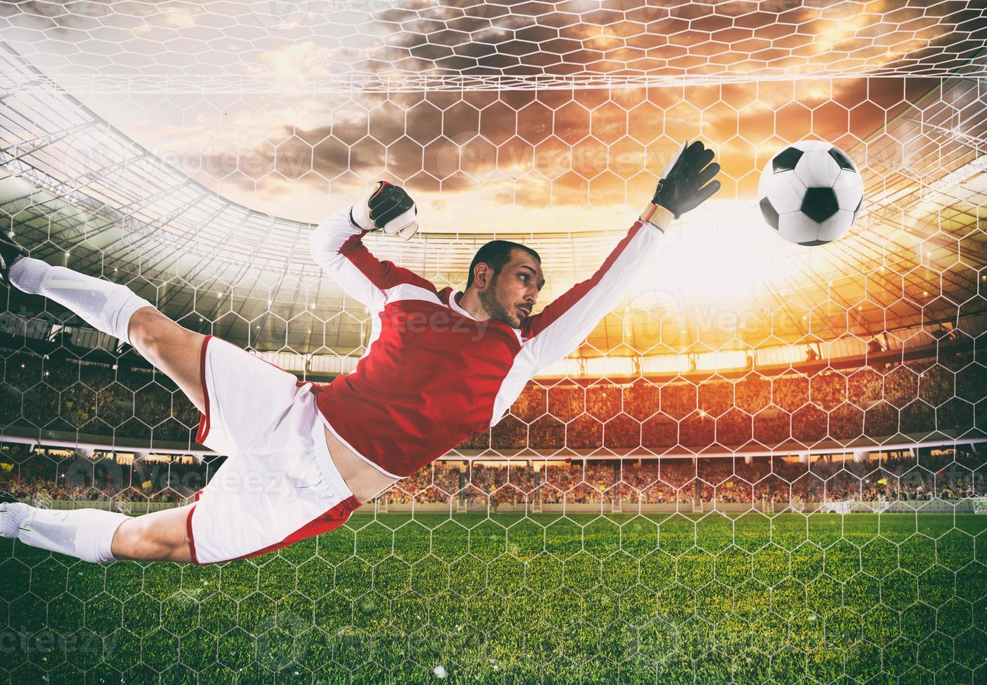 Goalkeeper catches the ball in the stadium during a football game photo