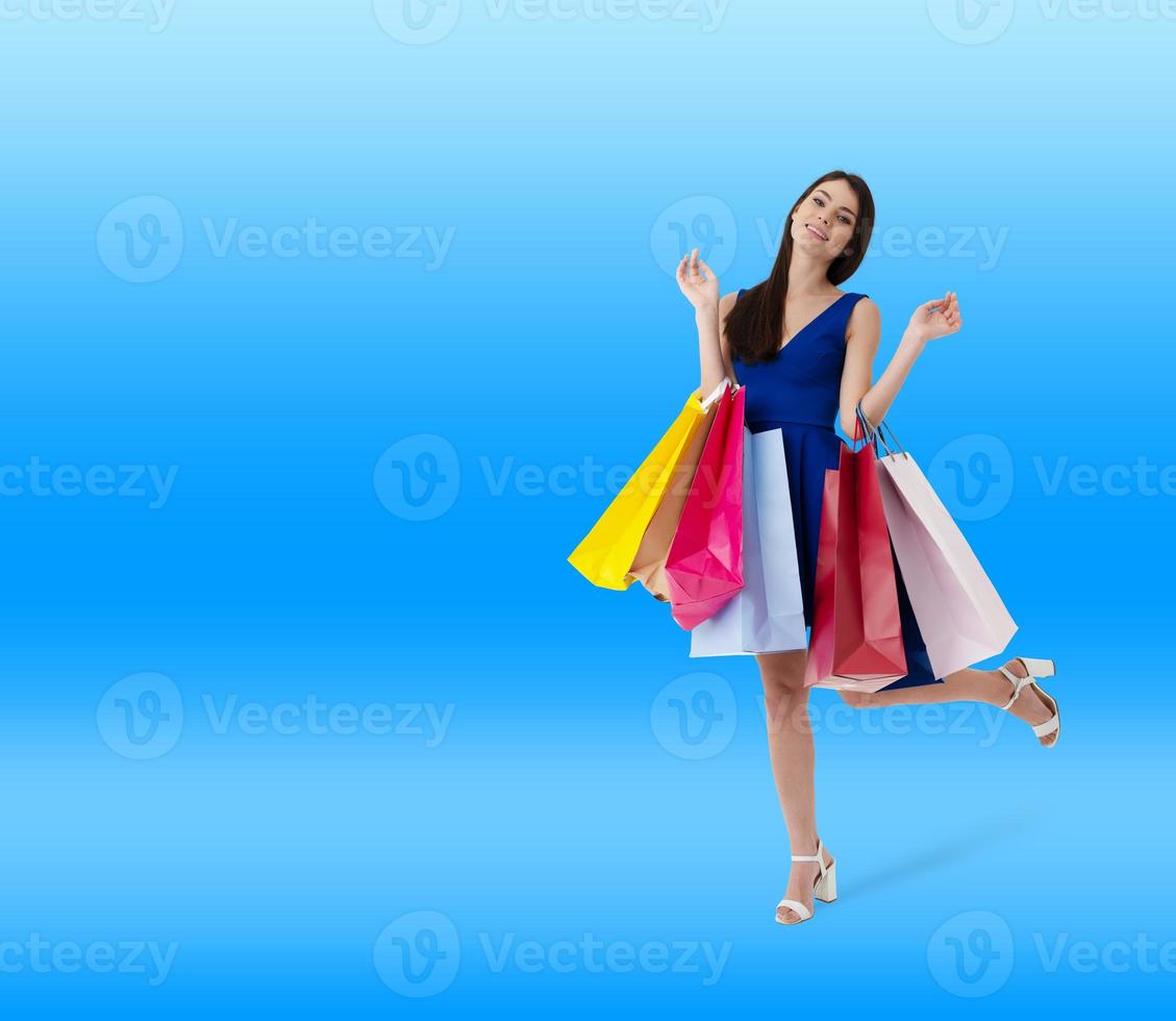 Happy woman with shopping bags in hand photo