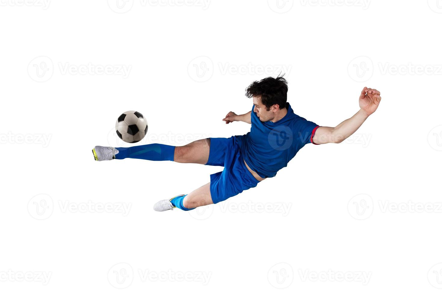 Football scene at night match with player kicking the ball with power. Isolated on white background photo